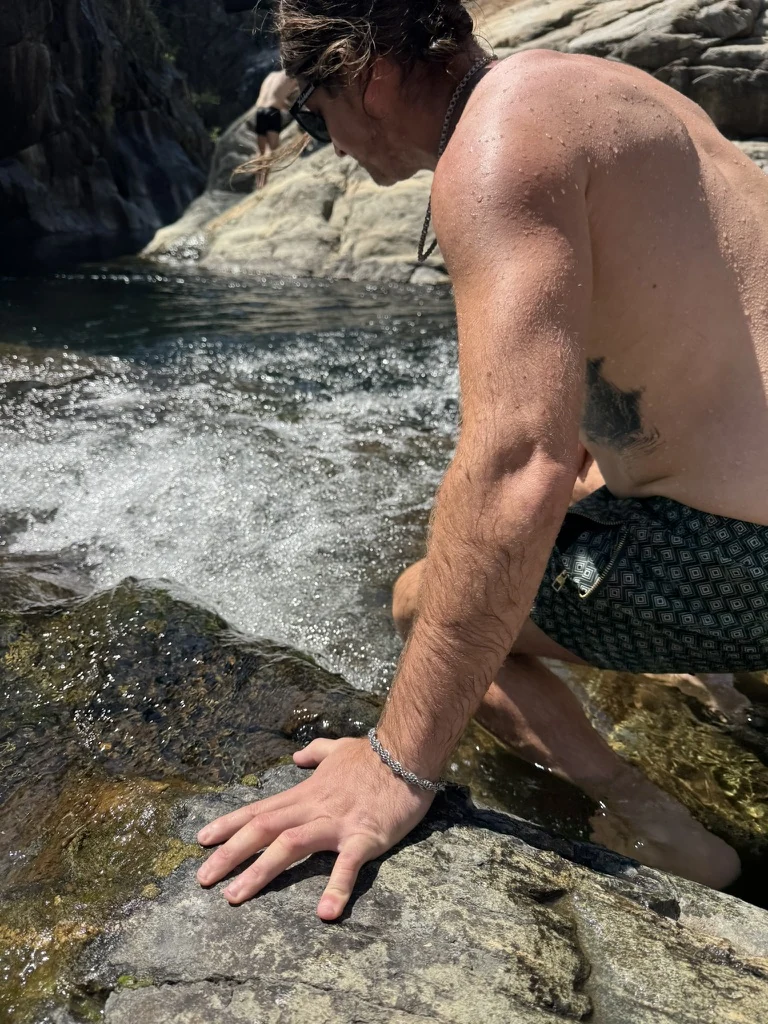 David Kloth beside rushing water and granite at Emerald Pools