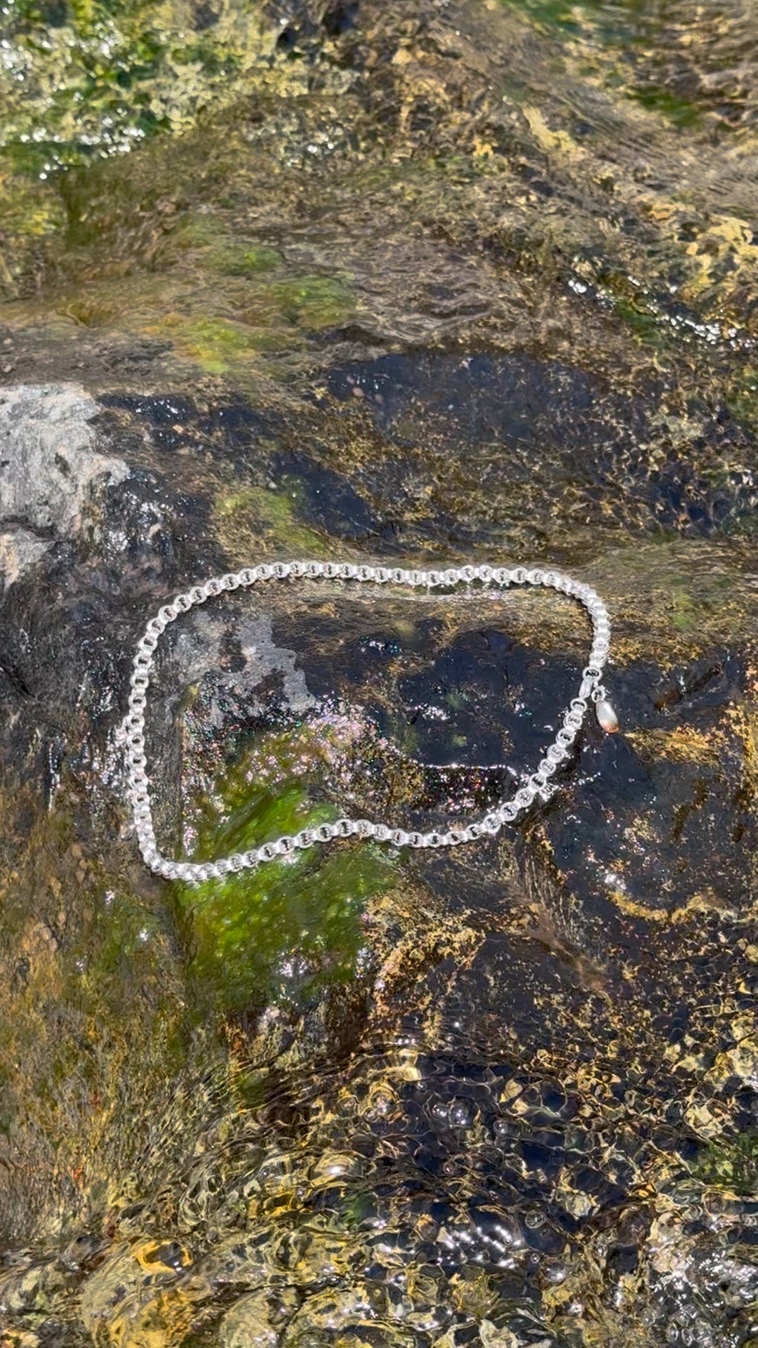 Steel Kloth bracelet resting on natural granite